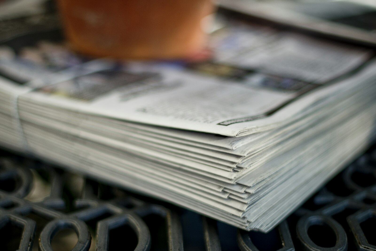 A bundled stack of printed newspapers